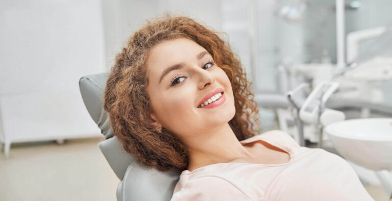 Uśmiechnięta pacjentka na fotelu stomatologicznym – higienizacja zębów Ez-Dent Oleśnica.